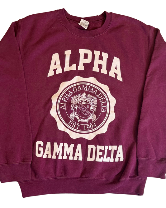 Alpha Gamma Delta burgundy crest crewneck sweatshirt